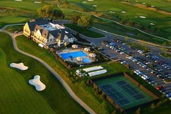 Aerial view of the Somerby pool and racquet courts beside the Clubhouse, with the golf course beyond